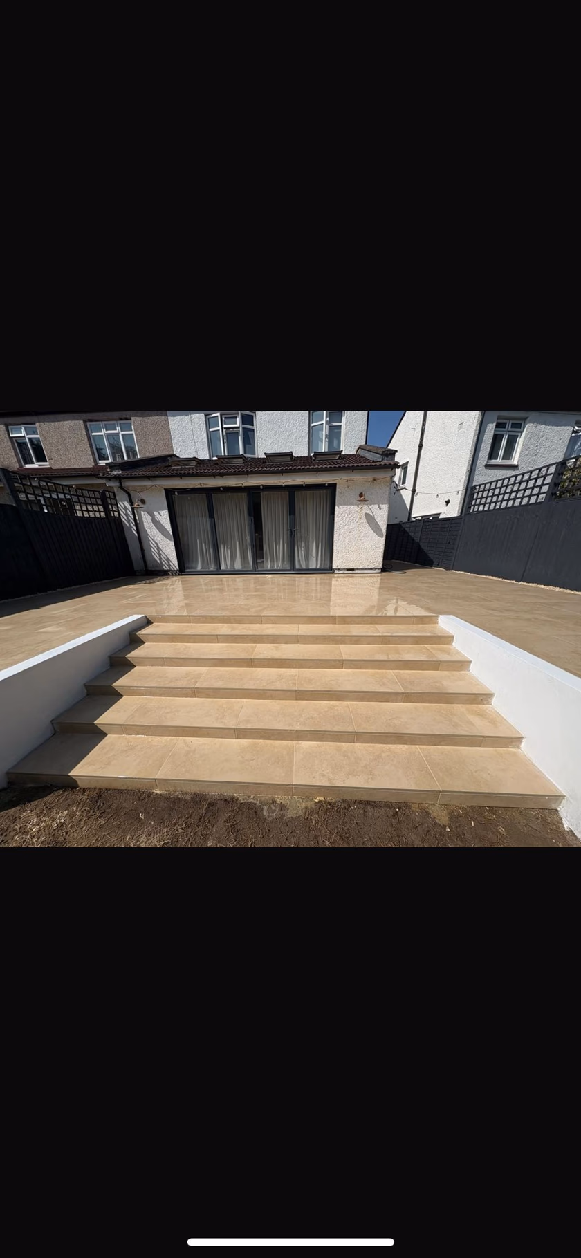 Raised porcelain patio with broad steps