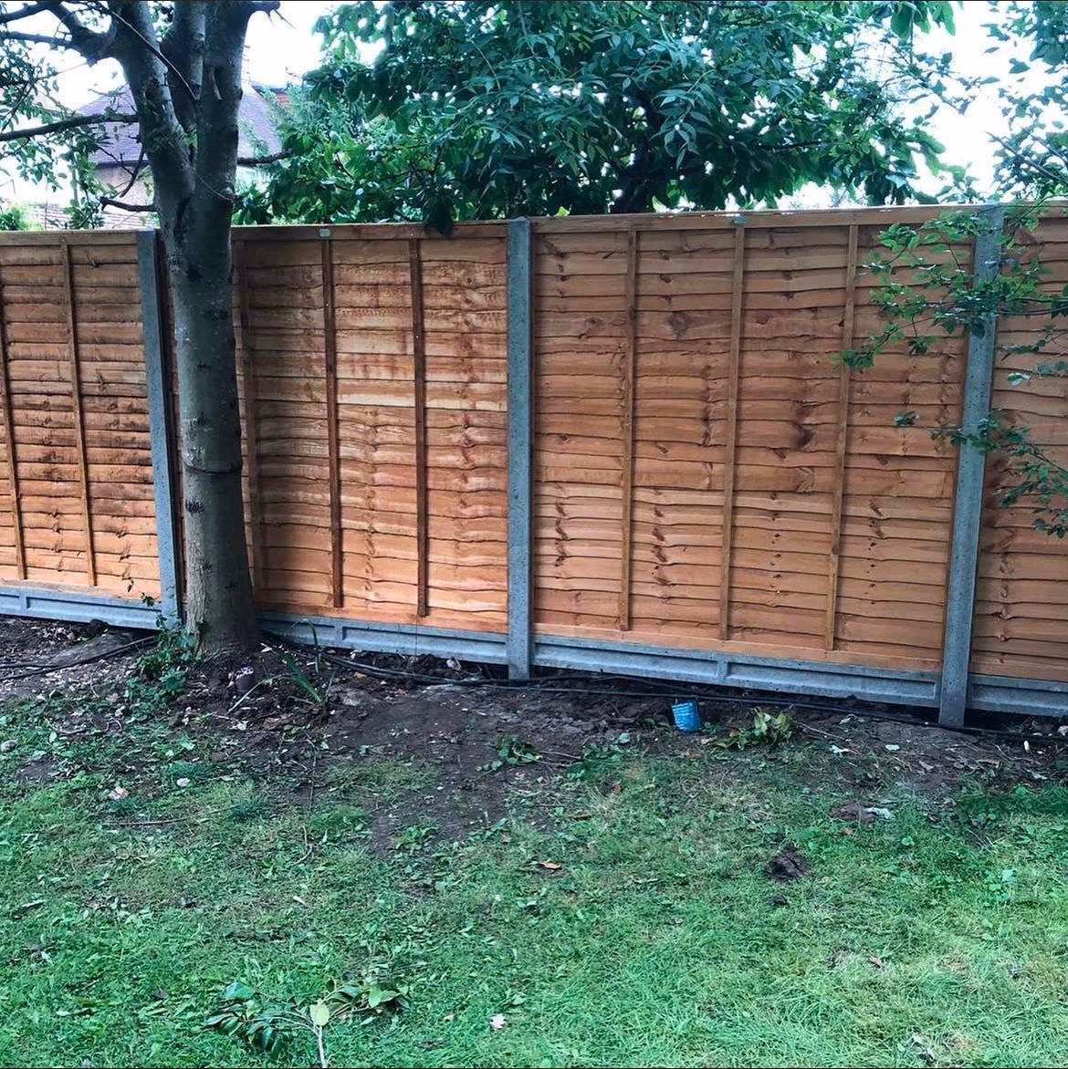 Panel fence with concrete posts